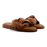 Step Ahead Pesso Bella tan leather slide sandals featuring a decorative knotted bow detail on the strap