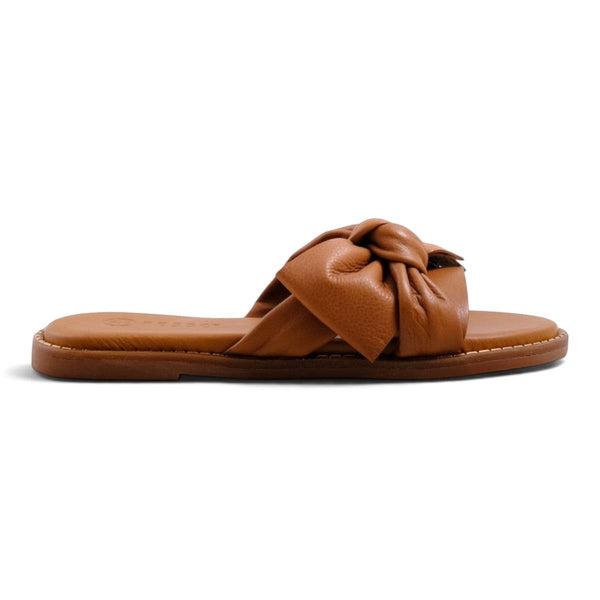 Step Ahead Pesso Bella tan leather slide sandals featuring a decorative knotted strap detail on a flat sole
