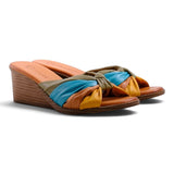 Step Ahead Pesso Tarin wedge sandals featuring a multi-coloured knotted leather strap in yellow, blue, and olive.
