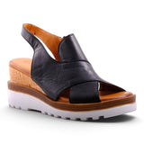 Step Ahead Pesso Well black leather wedge sandals with a cork midsole and white lugged rubber outsole.